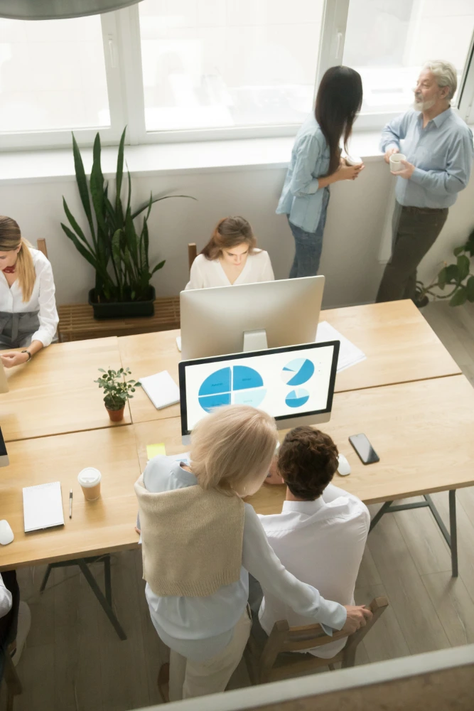 A B2B sales team reviewing campaign performance and pipeline data in a modern office environment.